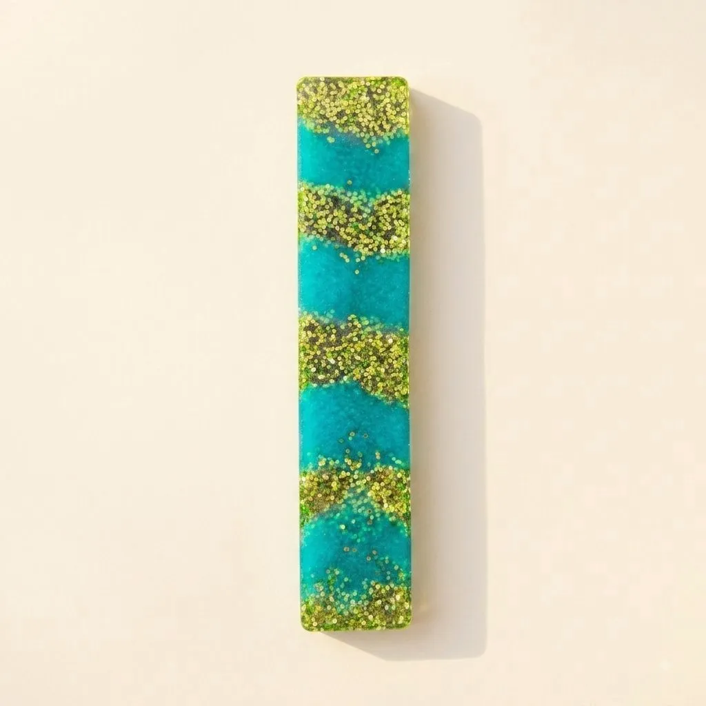 Rounded rectangle bookmark in teal bands alternating with diagonal gold-green glitter