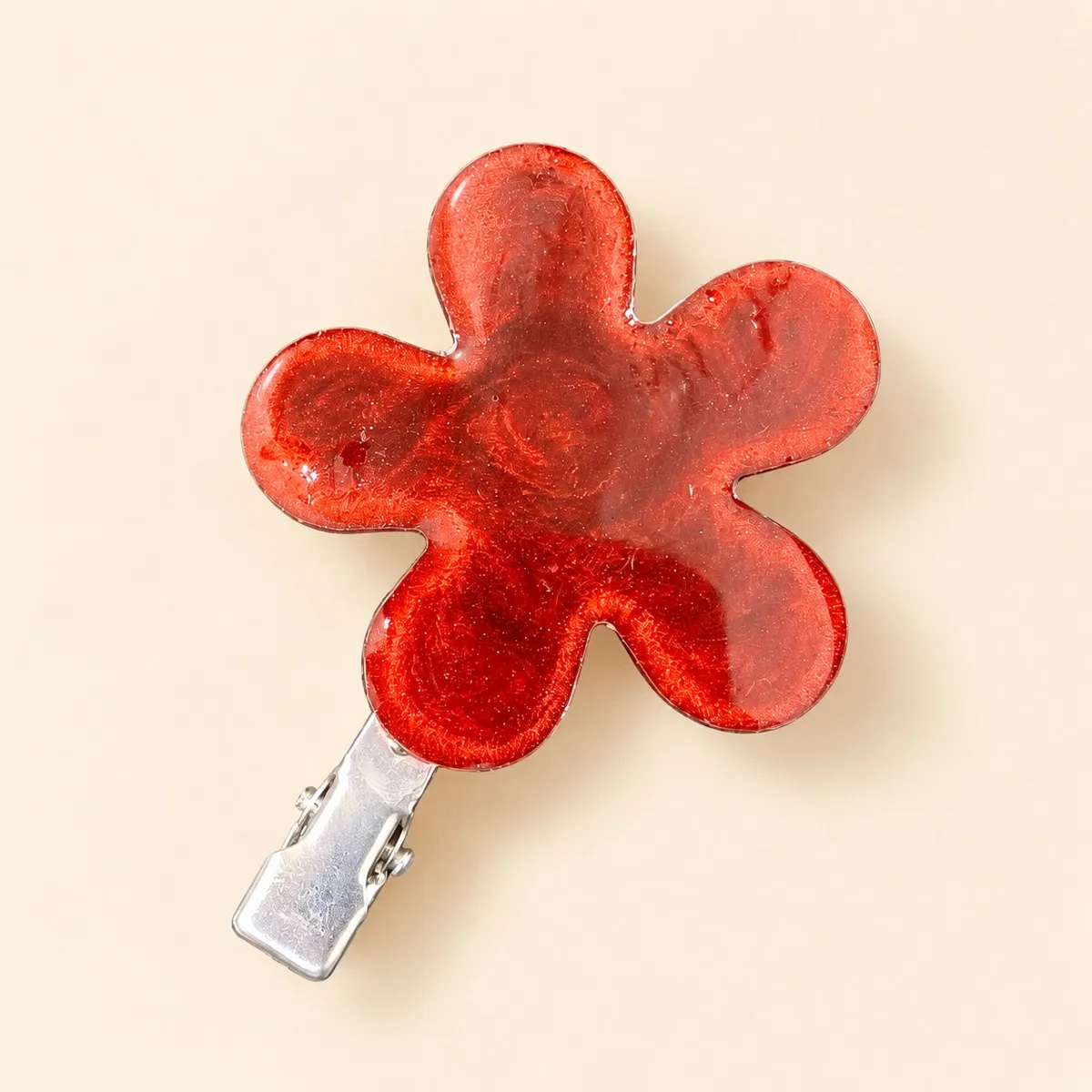 Deep maroon five-petal resin flower hair clip with fine glitter swirled through it and a high gloss finish, on a silver alligator clip